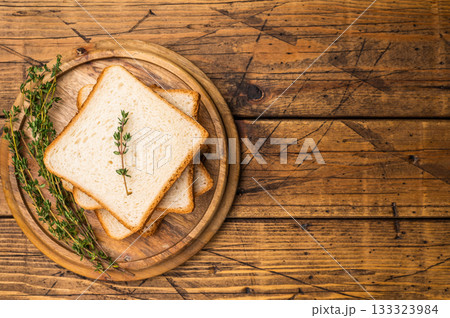 Ready for toasts Slices of wheat bread. wooden background. top view 133323984
