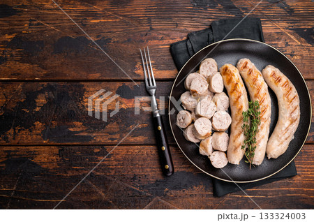 Grilled Sausages with forcemeat mincemeat and herbs in plate. wooden background. top view Grilled Sausages with forcemeat mincemeat and herbs in plate. wooden background. top view 133324003
