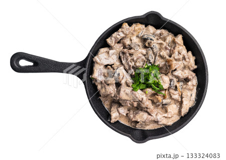 Creamy beef stroganoff with fresh greenery, savory mushroom sauce and caramelized onions in a skillet isolated on white background. top view Creamy beef stroganoff with fresh greenery, savory mushroom sauce and caramelized onions in a skillet isolated on white background. top view 133324083