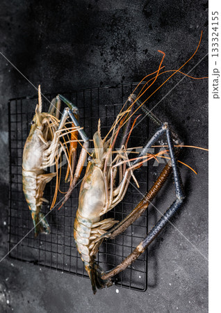 Fresh raw rosenbergii shrimp prawn, perfect for gourmet dishes and seafood lovers seeking premium quality.black background. top view Fresh raw rosenbergii shrimp prawn, perfect for gourmet dishes and seafood lovers seeking premium quality.black background. top view 133324155