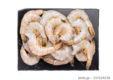 Uncooked Raw headless white shrimps prawns isolated on white background. 133324236