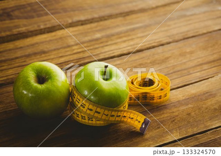 Green apples and measuring tape 133324570