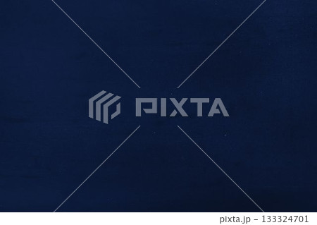 Dark navy blue textured surface is filling entire frame in flat design, showing subtle grain 133324701