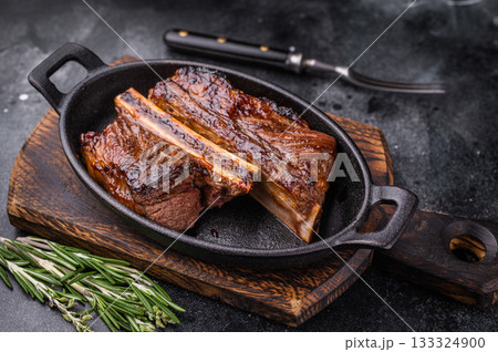 Gourmet grilled short ribs on a dark background with plenty of negative space for custom text or design. 133324900