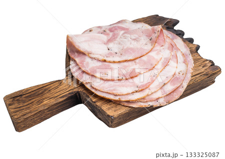 Overhead studio shot of premium deli meat (Pancetta) on a dark wooden plank. Clean white background for easy cutout. 133325087