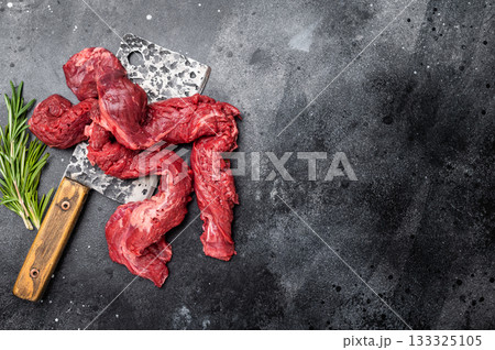Alternative Beef cut Machete Skirt Steak, raw prime meat on butcher table. black background. top view Alternative Beef cut Machete Skirt Steak, raw prime meat on butcher table. black background. top view 133325105
