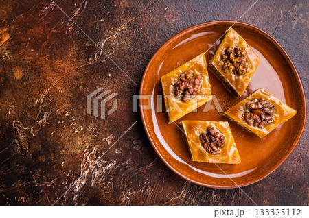 Delicious Honey Walnut Baklava on plate. brown background. top view 133325112