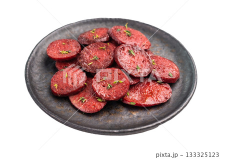Pan-fried Turkish sucuk (sujuk) slices garnished with thyme on a dark plate. Spicy sausage breakfast or appetizer. 133325123