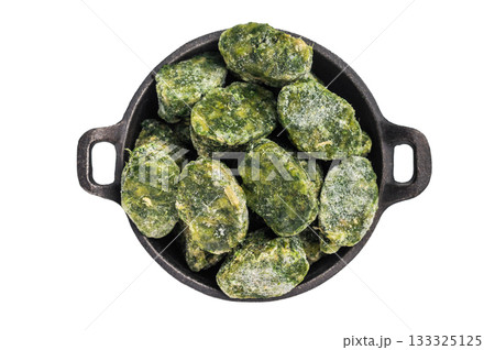 Top view of frozen spinach blocks in a dark cast iron bowl, isolated on a white background. Healthy vegetable ingredient. Top view of frozen spinach blocks in a dark cast iron bowl, isolated on a white background. Healthy vegetable ingredient. 133325125