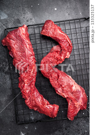 Raw Beef Steak Machete, uncooked meat . black background. top view 133325137
