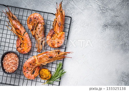 Seafood BBQ with Grilled red Argentine shrimps, Prawns Langostino Austral on a rack with herbs. grey background. top view 133325138
