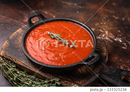 Tomato sauce passata in a skillet , traditional recipe of italian cuisine. brown background. top view 133325236