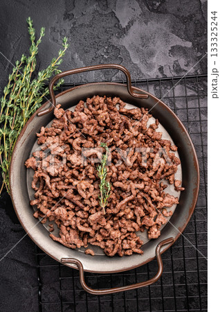 Fried mince beef and pork meat, fresh cooked mincemeat. black background. top view Fried mince beef and pork meat, fresh cooked mincemeat. black background. top view 133325244