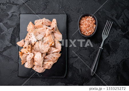 Shredded salmon, roasted fillets on a marble board. black background. Top view 133325272