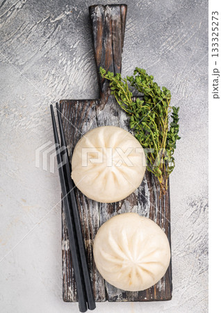Traditional Dumpling Momos with meat on wooden board. white background. top view Traditional Dumpling Momos with meat on wooden board. white background. top view 133325273