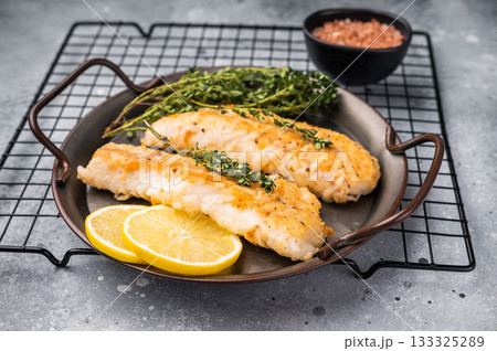 Baked Cod fish fiilet, fried whitefish meat. Grey background. top view 133325289