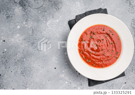 Tomato soup with thyme in plate. grey background. top view 133325291