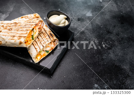 Oriental Doner kebab wrap, Shawarma with beef meat and salad. black background. top view 133325300