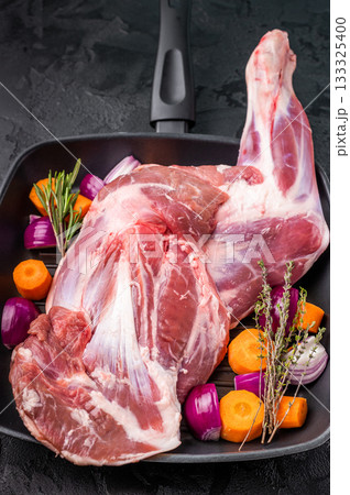 High quality raw lamb shoulder leg, an essential ingredient for hearty stews and savory dishes. black background. top view High quality raw lamb shoulder leg, an essential ingredient for hearty stews and savory dishes. black background. top view 133325400
