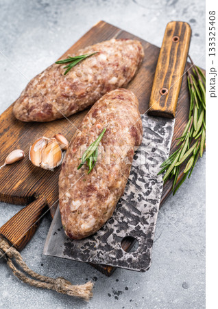 Succulent raw kofta kebab pieces marinated in spices, ideal for grilling enthusiasts looking to elevate their barbecue game. grey background. top view 133325408