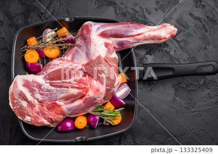 High quality raw lamb shoulder leg, an essential ingredient for hearty stews and savory dishes. black background. top view 133325409