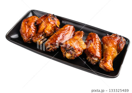 Mouthwatering BBQ chicken wings, coated in a rich sauce, perfect for finger-licking appetizers at any gathering. isolated on white background. top view 133325489