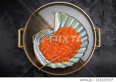 Bright red caviar, a gourmet delight that adds a burst of flavor to any dish or celebration. grey background. top view 133325557