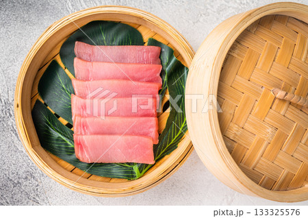 Artful presentation of fresh tuna sashimi, a deliciously healthy choice that delights the senses and pleases the palate. white background. top view Artful presentation of fresh tuna sashimi, a deliciously healthy choice that delights the senses and pleases the palate. white background. top view 133325576
