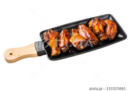 Mouthwatering BBQ chicken wings, coated in a rich sauce, perfect for finger-licking appetizers at any gathering. isolated on white background. top view Mouthwatering BBQ chicken wings, coated in a rich sauce, perfect for finger-licking appetizers at any gathering. isolated on white background. top view 133325661