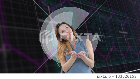 Presenting woman wearing blue blouse gesturing in virtual set, with grid and chart overlay 133326155
