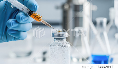 Vaccine and medical research concept with scientist hand holding syringe and vial, doctor preparing injection for vaccination or treatment in modern laboratory 133326411