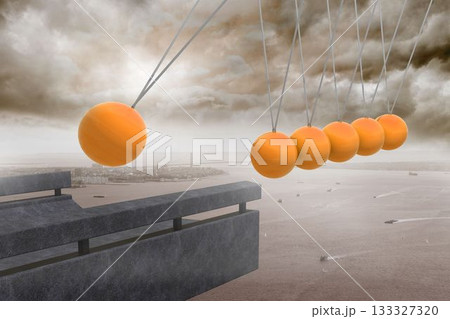 Newtons cradle above coastline 133327320