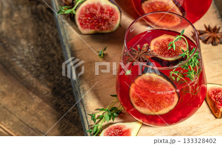 Refreshing fig cocktail with herbs and spices on wooden table, close up, copy space Refreshing fig cocktail with herbs and spices on wooden table, close up, copy space 133328402