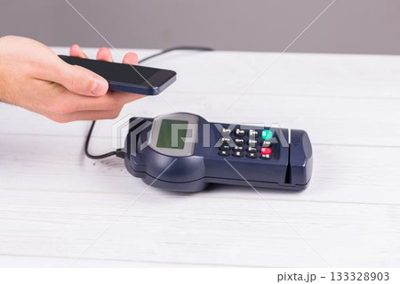 Man using smartphone to express pay Man using smartphone to express pay 133328903