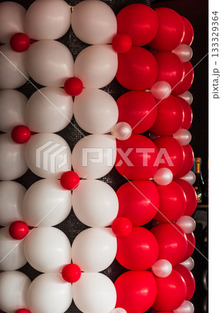 Red and white balloons decorating a wall for wedding reception Red and white balloons decorating a wall for wedding reception 133329364