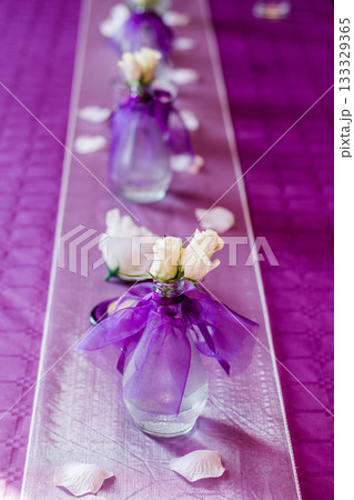 White roses decorating wedding table with purple runner White roses decorating wedding table with purple runner 133329365