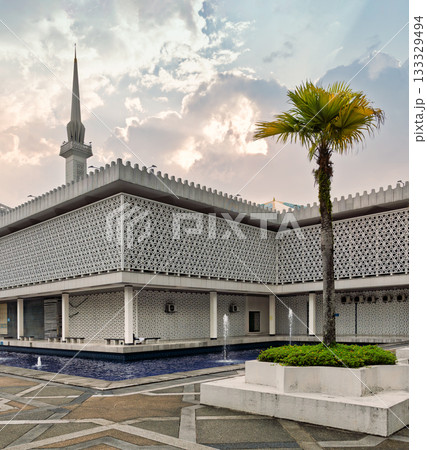 Masjid Negara, National Mosque of Malaysia: Exterior with minaret, geometric patterns, and palm tree, Kuala Lumpur, Malaysia. 133329494