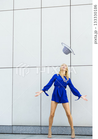 Fashion model throwing hat Fashion model throwing hat 133330186
