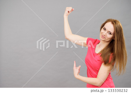 Woman flexing biceps 133330232