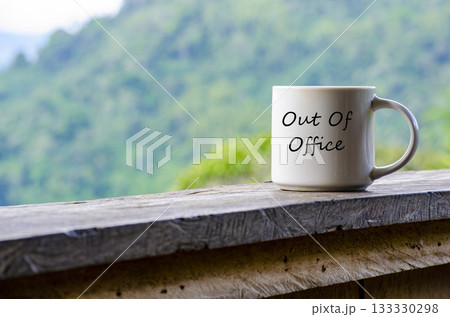 Out Of Office text on a mug with nature beauty background. Out Of Office text on a mug with nature beauty background. 133330298