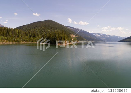 Calm river and mountains against sky 133330655