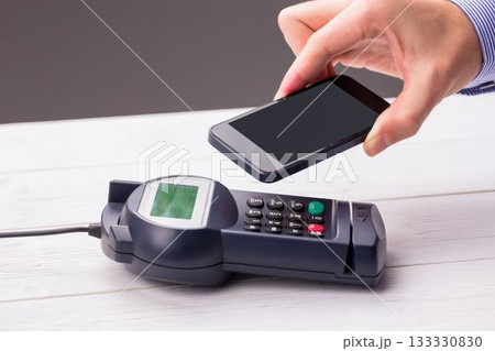 Man using smartphone to express pay Man using smartphone to express pay 133330830