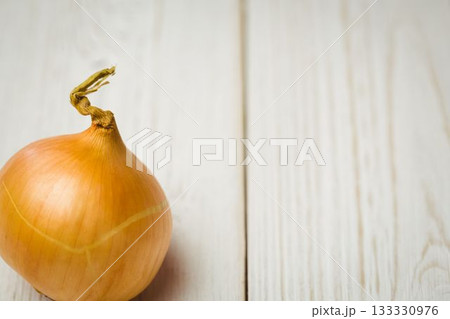 Fresh onion on wooden table 133330976