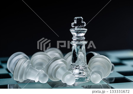 glass chess board game in black background ,selective focus on King, winner concept glass chess board game in black background ,selective focus on King, winner concept 133331672