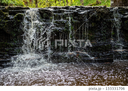 beautiful view in spring of a waterfall on small river Ivande in Latvia 133331706