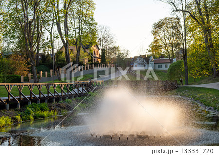 Fountain in the evening sunlight in Kuld?ga city park, Latvia 133331720