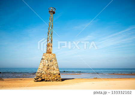 abandoned ruins of Kurmrags Lighthouse on the shore of the Rigas Gulf, Baltic sea, Latvia 133332102