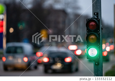 traffic light on the street junction with beautiful bokeh, city with cars in the background 133332112