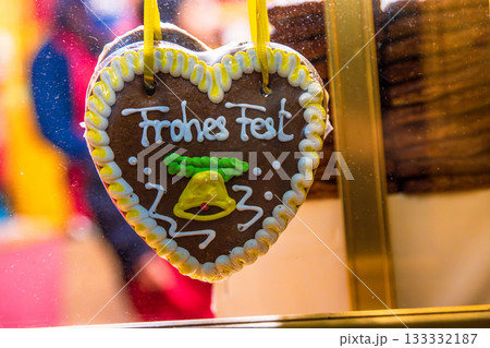 Close up of Frohes Fest - Happy Holiday gingerbread  heart. Handcrafted sweets during German Christmas market season. 133332187