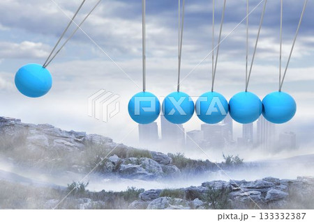 Newtons cradle above city in mountains 133332387